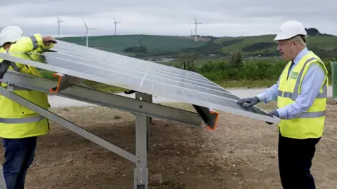 Getty Images Boris Johnson visiting a solar farm in Cornwall