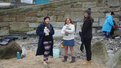 Swimmers with hot water bottles