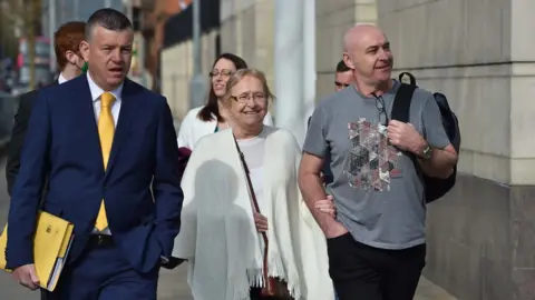 Pacemaker Joe McCann's family arrive at court with their solicitor Niall Murphy