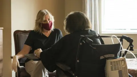 Getty Images Visitor at care home