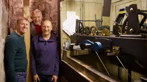 Ian Wylie Volunteers Mike Collins, Michael Rae and Paul Morris with the mechanism