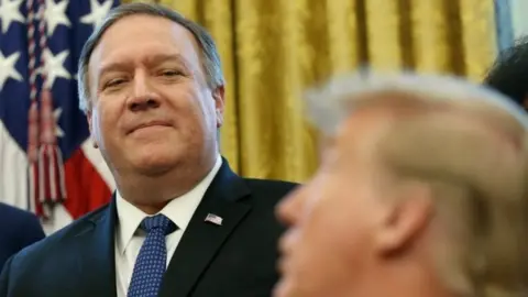 Reuters Mike Pompeo standing next to Trump