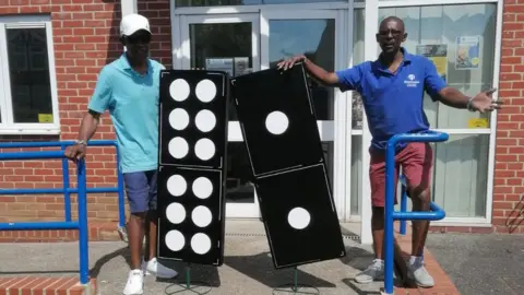 Lawrence Walker Lawrence Walker and Max Thomas with giant dominoes