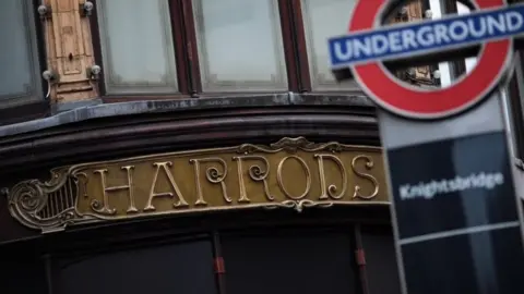 Getty Images A London Underground sign stands in front of the Harrods department store