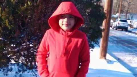 Family via GoFundMe Cristian Pineda wearing a red hoodie in snow