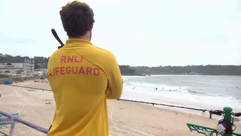 BBC Lifeguard patrolling at St Brelades beach