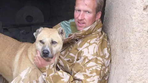 Nowzad Pen Farthing with a rescue dog