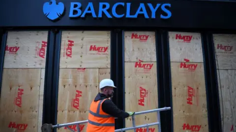 Andy Buchanan Getty Images Barclays bank in Glasgow with boarded-up windows after a protest