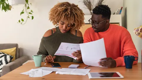 Getty Images Couple looking at bills
