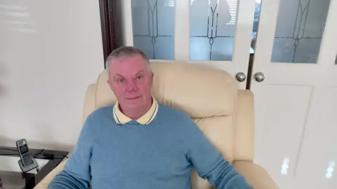 Dale Allen Dale Allen, sitting in a chair