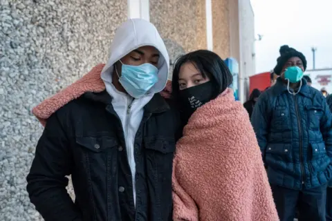 Getty Images Queues have formed at shops in Texas where many are unused to freezing temperatures