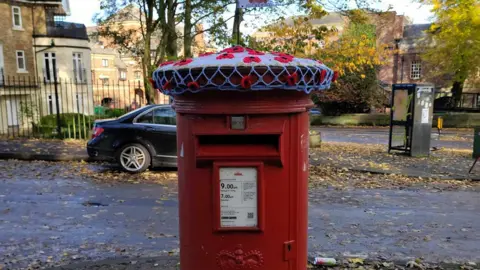 Andrew Lofthouse Poppy topper on York post box