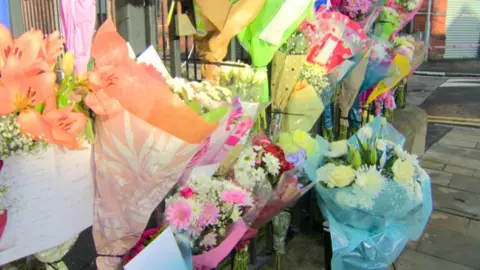 Flowers near the scene of Ian Ogle's murder