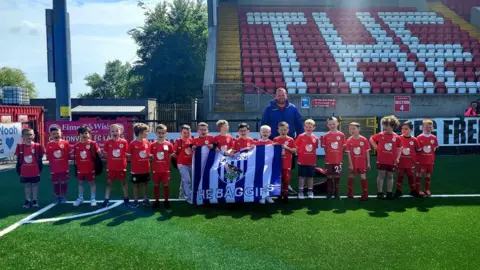 Cliftonville Football Club  The group got their photo taken at Cliftonville Football Club on Friday