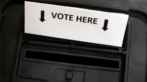 Reuters A ballot box is photographed inside a polling station on general