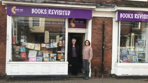 Books Revisited Volunteers in front of the Books Revisited charity shop