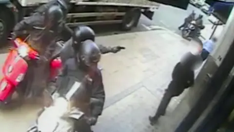 Metropolitan Police Moped drivers holding up pedestrians