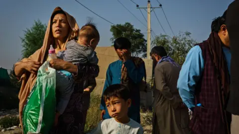 Marcus Yam/Getty Images Afghans making their way to the airport in Kabul
