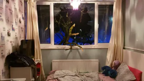 Avon Fire and Rescue Branches of a tree that came through the window in a block of flats in Hanham