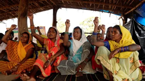 Pritam Roy People protest under a thatched tent near Hariharpur