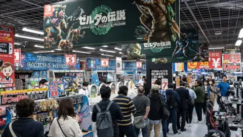 Getty Images People queue up to buy Legend of Zelda game Tears of the Kingdom in Tokyo on May 12, 2023