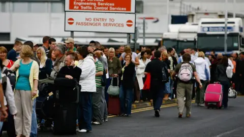 Getty Images Passengers queue at Glasgow Airport after an incident with a car being driven at the airport's main terminal July 1, 2007 in Glasgow, Scotland.