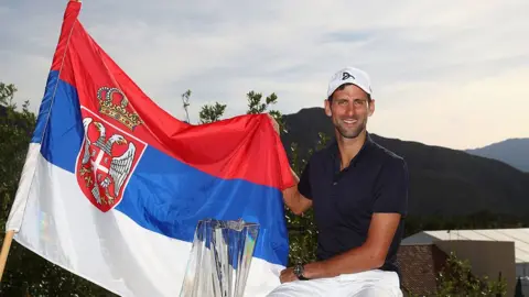 Getty Images Novak Djokovic poses with a Serbian flag in 2016
