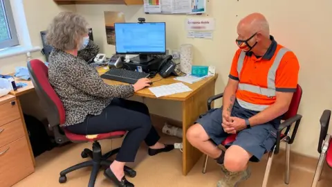 Nikki Fox/BBC Dr Caroline Dollery treating a patients