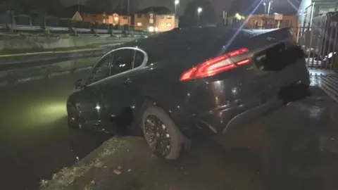 Greater Manchester Police Taxi in canal