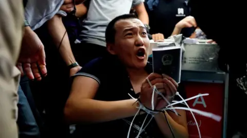 Reuters Global Times reporter Fu Guohao tied up by protesters