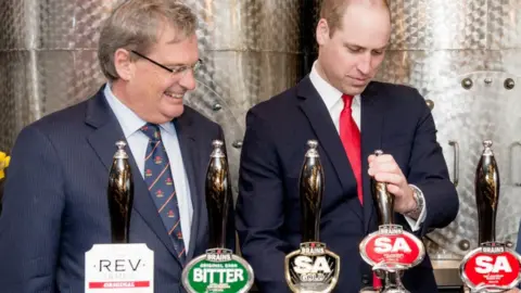 Getty Images Prince William pulls a pint of Brains with Brains chairman John Rhys a few years ago