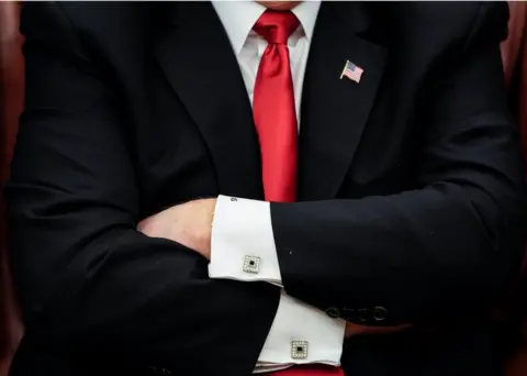 Reuters Donald Trump folds his arms