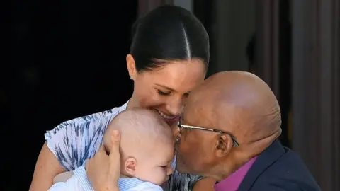 Reuters The Duchess of Sussex and baby son Archie meet Archbishop Desmond Tutu