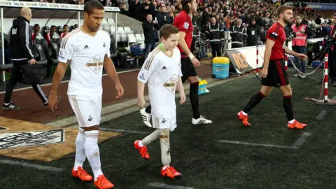 Getty Images Swansea City mascot with player