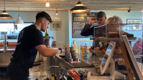 BBC Bar worker serves two customers