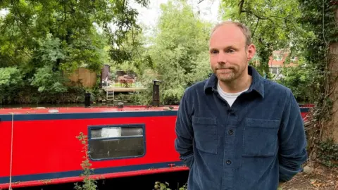 Tim Wiseman in front of his boat