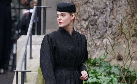 PA Media Elle Fanning arrives for a memorial service to honour and celebrate the life of fashion designer Dame Vivienne Westwood at Southwark Cathedral, London