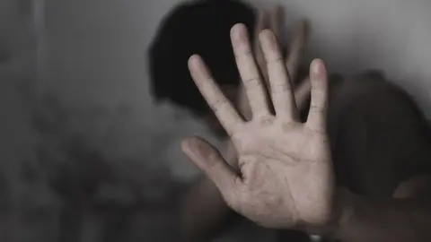 Getty Images Close up of hand and covered face