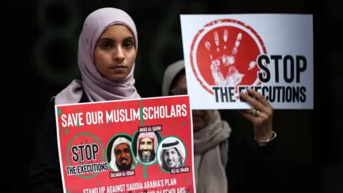 Getty Images Women protest outside the Saudi consulate in New York on 1 June 2019 to protest against the trials of three clerics in Saudi Arabia