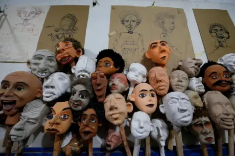 Reuters A jumble of handmade puppets of different complexions and facial features, at various stages of completion.