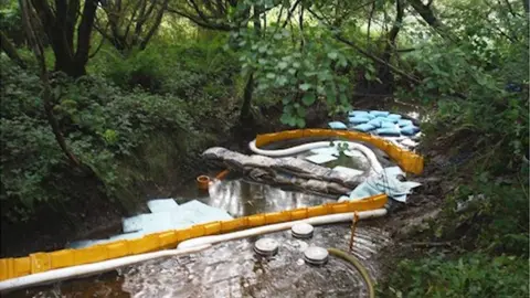 Natural Resources Wales Picture of work being done to contain the spread of the oil