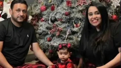 Umma Kannayan A photo of Vishal Patel (left), Bhavna Patel (right) and Aishani (centre)