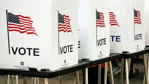 Voting booths with US flags on them