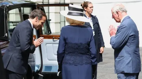 PA Media Emmanuel Macron meets the Prince of Wales and the Duchess of Cornwall