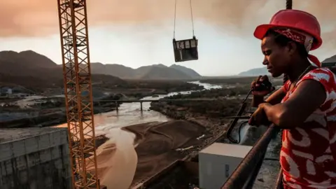 Getty Images Construction worker by the dam