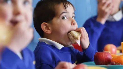 Getty Images Child eating sandwich