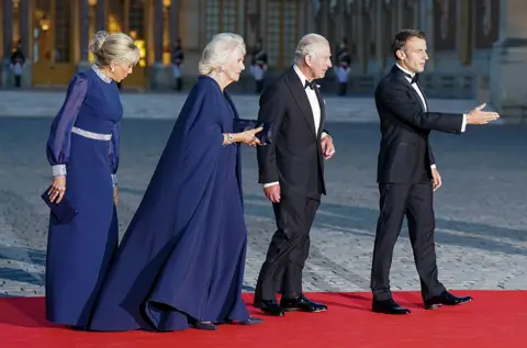Getty Images Brigitte Macron, Queen Camilla, King Charles III and French President Emmanuel Macron attending the State Banquet at the Palace of Versailles, Paris
