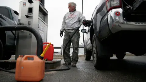 Getty Images Man fills up big car in US