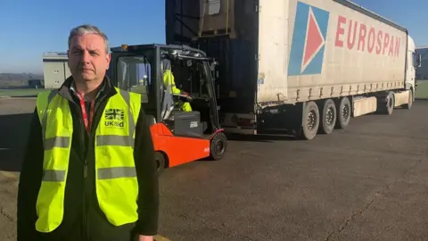 Charlie Mason standing outside a truck