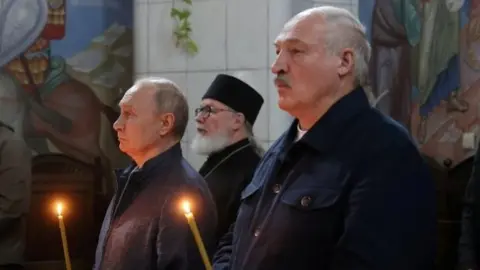 Reuters Russian President Vladimir Putin (L) and Alexander Lukashenko (R) at a church service in Karelia, Russia, in July
